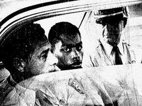 FILE - In this February 1964 file photo, Henry Montgomery, flanked by two deputies, awaits the verdict in his trial for the murder of Deputy Sheriff Charles H. Hurt in Baton Rouge, La. More than a half-century after the Louisiana teen was sent to prison for killing a sheriff's deputy, the now 71-year-old inmate is getting his first chance at freedom since the U.S. Supreme Court ruled in his favor. Louisiana's parole board scheduled a hearing Thursday, Dec. 14, 2017, for Montgomery.