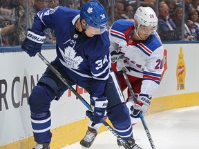 Chris Kreider of the New York Rangers battles against Auston Matthews of the Toronto Maple Leafs in an NHL game on Oct. 7, 2017