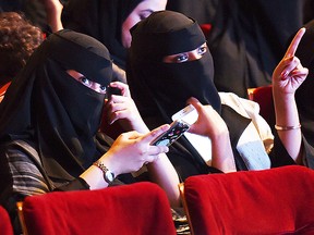 (FILES) This file photo taken on October 20, 2017 shows Saudi women attending the "Short Film Competition 2" festival at King Fahad Culture Center in Riyadh. Saudi Arabia on Monday announced a lifting of the kingdom's decades-long ban on cinemas, a landmark decision part of a series of social reforms ushered in by the powerful crown prince.  / AFP PHOTO / FAYEZ NURELDINEFAYEZ NURELDINE/AFP/Getty Images