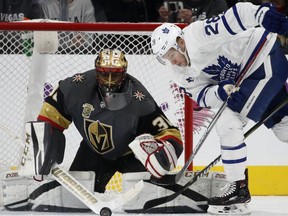 Vegas Golden Knights goaltender Malcolm Subban, left, blocks a shot by Toronto Maple Leafs right wing Connor Brown, right, during the second period of an NHL hockey game Sunday, Dec. 31, 2017, in Las Vegas.