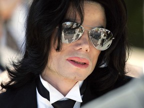 In this June 13, 2005 photo, Michael Jackson gestures as he leaves court during his trial on child molestation charges in Santa Maria, Calif.