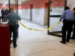 Police set up crime scene tape outside a Minneapolis police room at Minneapolis City Hall on Monday, Dec. 18, 2017.