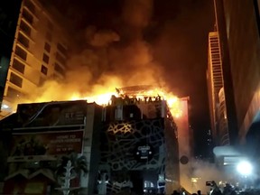 In this image made from video, a building is on fire in Mumbai, India, early Friday, Dec. 29, 2017. A number of people were killed and many more injured in a fire that broke out in a restaurant in Mumbai, India's financial and entertainment capital, early Friday, officials said. (Anand Shrivastav via AP)