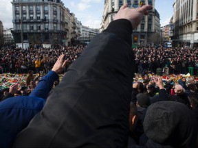 Far right hooligans make a Nazi salute, as they arrive in the square outside the stock exchange in Brussels on March 27, 2016 during a tribute to the victims of the Brussels terror attacks. A Vancouver concert promoter has banned hate speech at her shows after a man was witnessed making a Nazi salute.