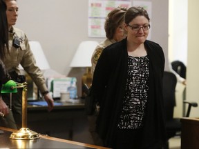 Nicole Finn is lead out of the courtroom in handcuffs Thursday, Dec. 14, 2017, after a jury found her guilty on kidnapping and murder charges in the starvation death of 16-year-old Natalie Finn at the Polk County Courthouse  in Des Moines, Iowa.( Michael Zamora/The Des Moines Register via AP, Pool)