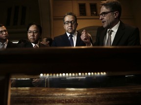 Egyptian Antiquities Minister Khaled el-Anani, second right, listens to German conservator Christian Eckmann, right, during their visit to see new exhibits entitled Tutankhamun's Unseen Treasures marking the 115th anniversary of the Egyptian museum in Cairo, Egypt, Wednesday, Nov. 15, 2017. Egypt has displayed for the first time some previously unseen artefacts of the Pharaoh, famous for his tomb full of golden treasures. (AP Photo/Nariman El-Mofty)