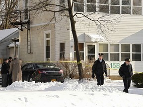 Troy police investigate multiple deaths at 158 Second Ave. on Tuesday, Dec. 26, 2017, in Troy, N.Y. Police say four people have been found dead and may have been killed in an apartment in New York's capital region. The bodies were discovered Tuesday afternoon in a basement apartment in a house in Troy, a city near Albany. Troy police say the deaths are being treated as suspicious.