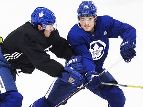 Ron Hainsey (L) battles William Nylander at Toronto Maple Leaf practice in Toronto on Monday December 4, 2017. Craig Robertson/Toronto Sun/Postmedia Network