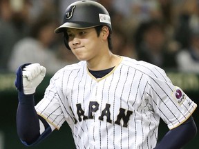 In this Nov. 12, 2016, file photo, Japan's designated hitter Shohei Ohtani reacts after hitting a solo home run
