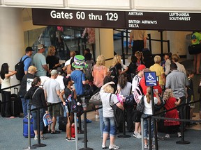 Airline passengers pass through security at Orlando International Airport in Orlando, Flin this 2011 file photo.    (STAN HONDA/AFP/Getty Images)