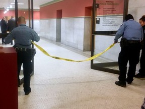 Police set up crime scene tape outside a Minneapolis police room at Minneapolis City Hall on Monday, Dec. 18, 2017.