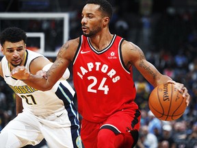 Toronto Raptors forward Norman Powell, front, drives past Denver Nuggets guard Jamal Murray in the first half of an NBA basketball game Wednesday, Nov. 1, 2017, in Denver. (AP Photo/David Zalubowski)