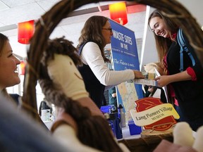 Co-ordinator Jill Chapman of Lang Pioneer Village, left, looks on as manager of waste Laurie Westaway chats with student Rachelle Law during Trent University's Career Centre's annual Summer Job Fair held at Gzowski College on Wednesday, Jan. 14, 2015.