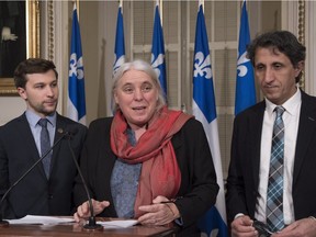 Quebec Solidaire MNA Manon Masse speaks at a news conference marking the end of the falls session, Friday, December 8, 2017 at the legislature in Quebec City. Quebec Solidaire colleagues Gabriel Nadeau-Dubois, left, and Amir Khadir look on. THE CANADIAN PRESS/Jacques Boissinot