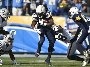 Los Angeles Chargers running back Melvin Gordon runs up the middle during the first half of an NFL football game against the Oakland Raiders, Sunday, Dec. 31, 2017, in Carson, Calif.