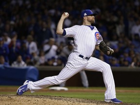 In this Wednesday, Oct. 18, 2017, file photo, Chicago Cubs relief pitcher Wade Davis throws during Game 4 of the National League Championship Series against the Los Angeles Dodgers.