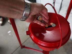 A donation is made into a Salvation Army red kettle on Giving Tuesday on November 28, 2017 in Hallandale, Florida.