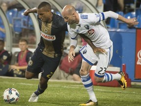 Philadelphia Union's Jay Simpson, left, and Montreal Impact's Laurent Ciman battle for the ball during second half MLS soccer action in Montreal on Wednesday, July 19, 2017. Peter McCabe / THE CANADIAN PRESS