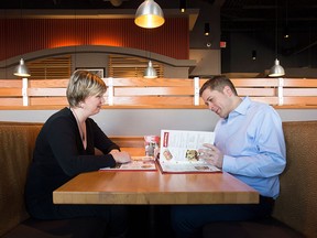 Conservative Leader Andrew Scheer, right, looks over a menu with his wife Jill at a restaurant in Ottawa on Monday Dec.r 11, 2017. THE CANADIAN PRESS/Adrian Wyld