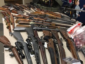 A table of weapons seized after Red Deer RCMP executed search warrants on a storage locker in north Red Deer on November 5 and a residence on November 22.