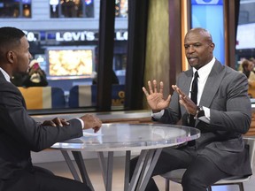 This image released by ABC shows actor Terry Crews, right with co-host Michael Strahan during a segment on "Good Morning America," Wednesday, Nov. 15, 2017, in New York.