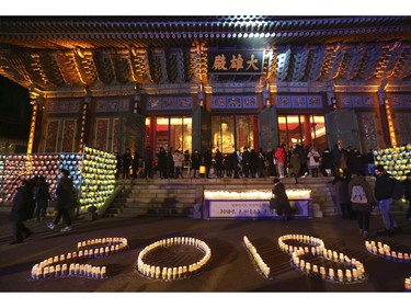 Buddhists light candles during New Year celebrations at Jogyesa Buddhist temple in Seoul, South Korea, Monday, Jan. 1, 2018.