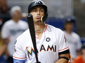 In this Aug. 31, 2017 file photo, Miami Marlins' Giancarlo Stanton reacts after he flies out against the Philadelphia Phillies