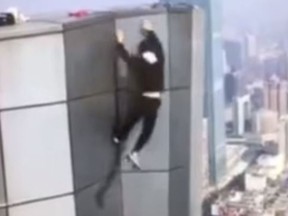 Chinese rooftopper Wu Yongning's fell to his death after losing grip from the roof of a building on Nov. 8. The incident was captured on video. (YouTube/The Star Online)