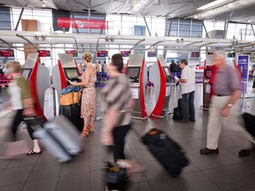 Passengers walk to check in at the domestic terminal of Sydney airport in Sydney, Australia, on Wednesday, Feb. 22, 2012.