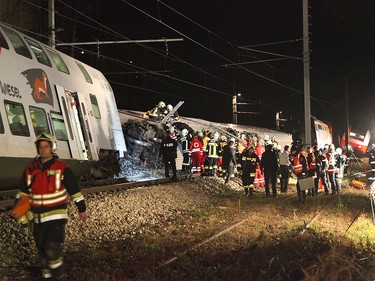 This handout photo made available by the Lower Austrian Fire Department shows members of the emergency services working at the scene when two passenger trains collided causing several carriages to derail in Kritzendorf, Lower Austria on Dec. 22, 2017. (APA AND LOWER AUSTRIAN FIRE DEPARTMENT/AFP/Getty Images/HO)