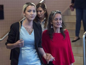 Miriam Saunders, right, mother of Loretta Saunders, along with her daughter Delilah Saunders, walk from the National Inquiry into Missing and Murdered Indigenous Women and Girls, in Membertou, N.S. on Monday, Oct. 30, 2017.