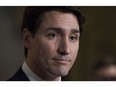 Prime Minister Justin Trudeau speaks with the media in the foyer of the House of Commons following the release of an ethics report in Ottawa on Wednesday December 20, 2017.