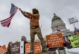 Protesters gather outside of the Utah State Capitol where President Donald Trump spoke to local representatives on Monday, Dec. 4, 2017, in Salt Lake City. Roughly 3,000 demonstrators lined up near the State Capitol to protest Trump's announcement of scaling back two sprawling national monuments, and his declaring that "public lands will once again be for public use." (Benjamin Zack/Standard-Examiner via AP)