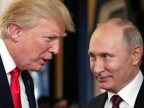 This file photo taken on November 11, 2017 shows U.S. President Donald Trump (left) speaking with Russian President Vladimir Putin as they attend the APEC Economic Leaders' Meeting in Danang, Vietnam.