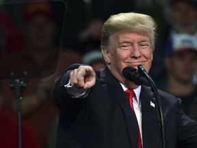 U.S. President Donald Trump points out an embattled Alabama Republican Senate candidate Roy Moore supporter as he speaks at a campaign-style rally at the Pensacola Bay Center, in Pensacola, Fla., Friday, Dec. 8, 2017.  (AP Photo/Susan Walsh)