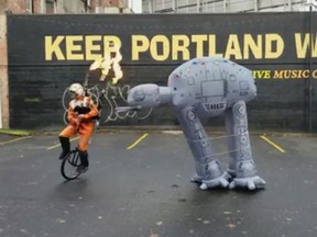 Brian Kidd, also known as The Unipiper, performs while playing flaming bagpipes while riding a unicycle. (Facebook/The Unipiper)