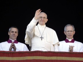 Pope Francis waves to faithful during the Urbi et Orbi (Latin for ' to the city and to the world' ) Christmas' day blessing from the main balcony of St. Peter's Basilica at the Vatican, Monday, Dec. 25, 2017. (AP Photo/Alessandra Tarantino)