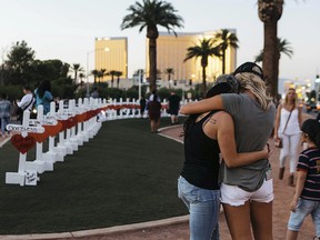 In this Oct. 5, 2017, file photo, a memorial displaying 58 crosses by Greg Zanis stands at the "Welcome To Las Vegas Sign" in Las Vegas.