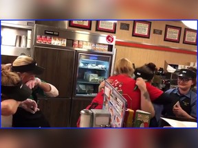 Employees at a Waffle House restaurant in Wapakoneta, Ohio, react after hearing they are receiving a $3,577 Christmas tip from the Grand Lake United Methodist Church. (Video screenshot/Grand Lake United Methodist Church)