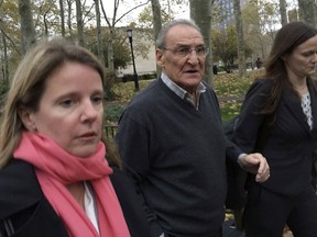 In this Nov. 12, 2015, file photo, Vincent Asaro, center, leaves federal court in the Brooklyn borough of New York, after he was acquitted of charges he helped plan a legendary 1978 Lufthansa heist retold in the hit film "Goodfellas." The legendary airport robbery has come back to haunt Asaro, an 82-year-old mobster who's been sentenced to eight years in prison for an unrelated road rage arson by a New York judge who cited the heist. He reacted to his sentencing Thursday, Dec. 28, 2017, with disgust, calling it a "death sentence." (AP Photo/Mike Balsamo, File)