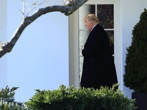 President Donald Trump walks from the Oval Office as he leaves the White House in Washington, Thursday, Dec. 21, 2017, to visit Walter Reed National Military Medical Center in Bethesda, Md.