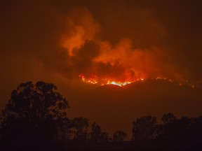 The Thomas Fire approaches the Lake Casita area on Saturday, Dec. 9, 2017 near Ojai, California. Strong Santa Ana winds have been feeding major wildfires all week, destroying hundreds of houses and forcing tens of thousands of people to stay away from their homes.