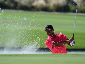 Tiger Woods hits from a bunker on the 17th hole during the final round of the Hero World Challenge golf tournament on Dec. 3, 2017