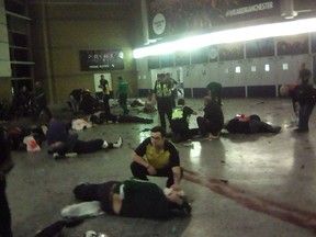 Helpers attend to injured people inside the Manchester Arena in Manchester, Britain, after a blast on May 22, 2017.