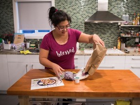 Jayne Zhu empties the contents of a bag containing a Hello Fresh cajun fish tacos meal kit, before preparing it at her home in Vancouver, B.C., on Wednesday December 6, 2017.