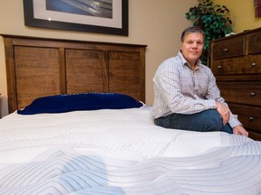 Mike Cleaver poses with a new waterbed at his mattress store in Barrie, Ont., on Thursday, Dec. 21, 2017. The waterbed industry has had its ups and downs over the decades. Mostly downs if you're looking at the past 30 years. But its most ardent supporters are buoyed by a modern wave of beds they say could shake its kitschy reputation once and for all, and maybe even bring it back into the mainstream.