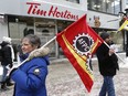Union workers and supporters gathered to demonstrate in front of Tim Hortons on Sparks Street in Ottawa Wednesday Jan 10, 2018.