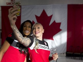Bobsleigh athletes Kaillie Humphries, right, takes a selfie with Phylicia George at the announcement of the Olympic bobsleigh and skeleton teams in Calgary on Jan. 24, 2018.