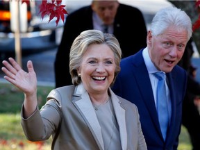 Hillary Clinton and former President Bill Clinton greet supporters after casting their ballots in Chappaqua, New York on November 8, 2016.