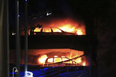 Vehicles burn during a blaze at a multi-storey car park at the Echo Arena on the waterfront in Liverpool, England Sunday, Dec. 31, 2017.  (Peter Byrne/PA via AP)